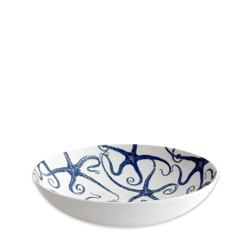 The Caskata Starfish Entrée Bowl is a white ceramic coastal dinnerware bowl featuring a blue octopus design inside, displayed on a plain white background. Dishwasher safe for easy cleaning.