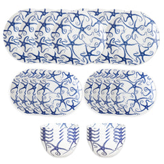 The Caskata Starfish Table for 8 is a blue and white porcelain dinnerware set with abstract patterns, featuring large plates, small plates, and bowls—ideal coastal dishes for an elegant table setting.