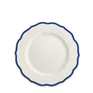 A top-view of the Stella Scalloped Blue Salad Plate by Caskata, featuring white porcelain with a scalloped edge and dark blue trim, evokes the charm of vintage dinnerware.