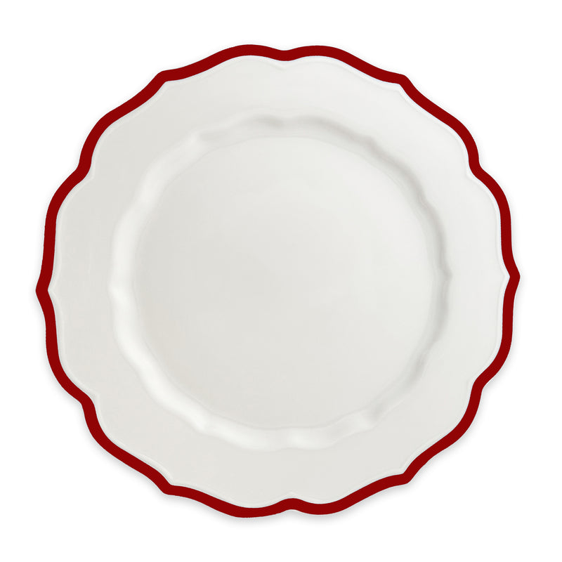 The Stella Scalloped Crimson Dinner Plate by Caskata is an heirloom-quality, high-fired porcelain plate with a scalloped edge and a bold red border, shown from above against a plain background.