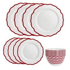 The Caskata Stella Red Table for 4 features elegant white plates with red scalloped rims and a white bowl with a red geometric pattern—a perfect porcelain dinnerware set for your holiday table.