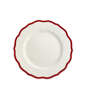The Caskata Stella Scalloped Crimson Salad Plate features white porcelain with a wavy red-edged rim, adding vintage charm to your table.