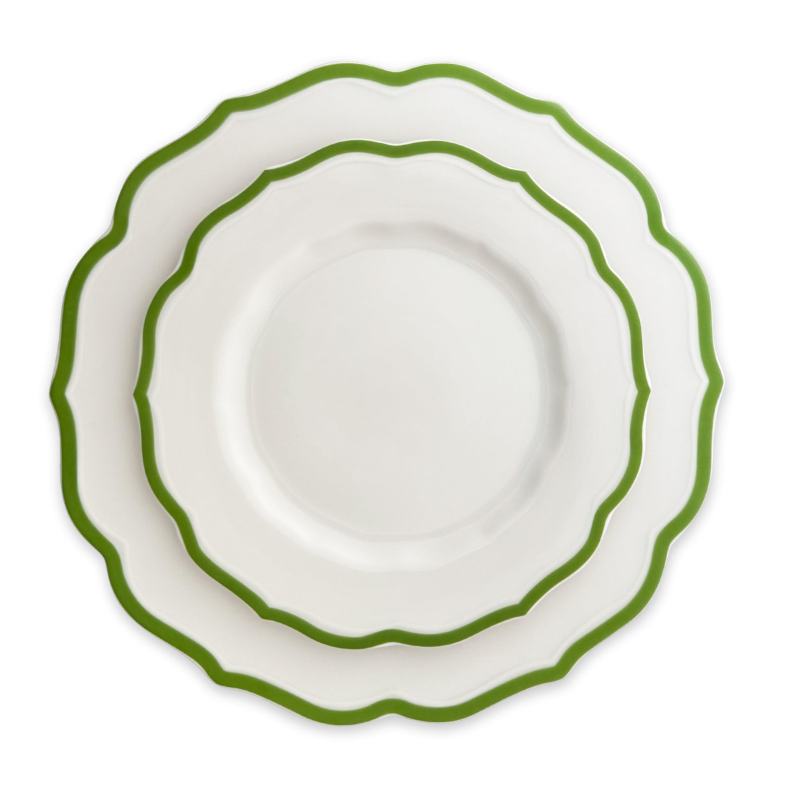 The Caskata Stella Verde Table for 8 is a 24-piece dinnerware set with twelve white porcelain dishes featuring green edges and twelve matching bowls, stacked in two groups on a white background—ideal tableware for eight.