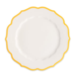 The Stella Scalloped Marigold Dinner Plate by Caskata features a white porcelain design with a decorative scalloped edge and yellow border, shown from above on a plain background.
