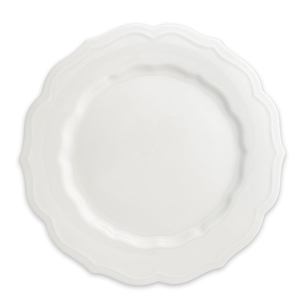 The Stella Scalloped White Dinner Plate by Caskata is a round porcelain dish featuring a scalloped edge, offering a vintage vibe that seamlessly complements any neutral palette or dinnerware design.