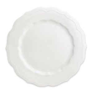 The Stella Scalloped White Dinner Plate by Caskata is a round porcelain dish featuring a scalloped edge, offering a vintage vibe that seamlessly complements any neutral palette or dinnerware design.