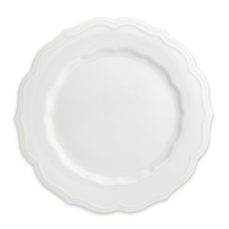 The Stella Scalloped White Dinner Plate by Caskata is a round porcelain dish featuring a scalloped edge, offering a vintage vibe that seamlessly complements any neutral palette or dinnerware design.