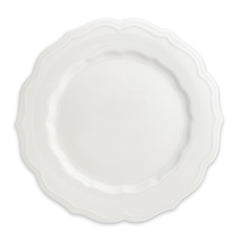The Stella Scalloped White Dinner Plate by Caskata is a round porcelain dish featuring a scalloped edge, offering a vintage vibe that seamlessly complements any neutral palette or dinnerware design.