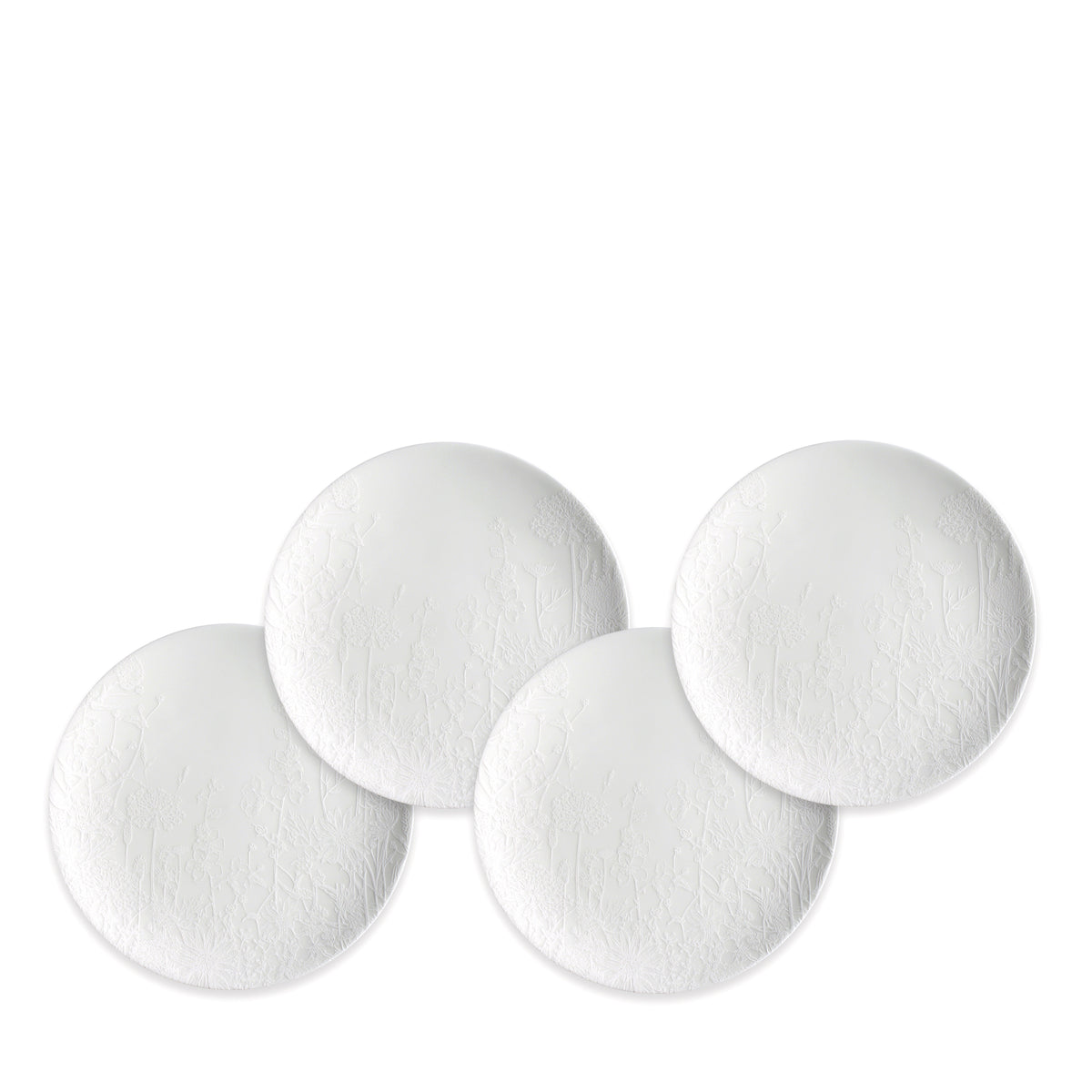 Four Caskata Summer White Small Plates, crafted from high-fired porcelain with a subtle textured floral design, are arranged in a slightly overlapping layout on a white background.