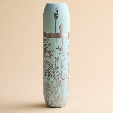 Caskata x High Camp Light Blue Summer Wine Flask by Caskata, featuring a silver floral pattern and matching lid, shown against a plain beige background.
