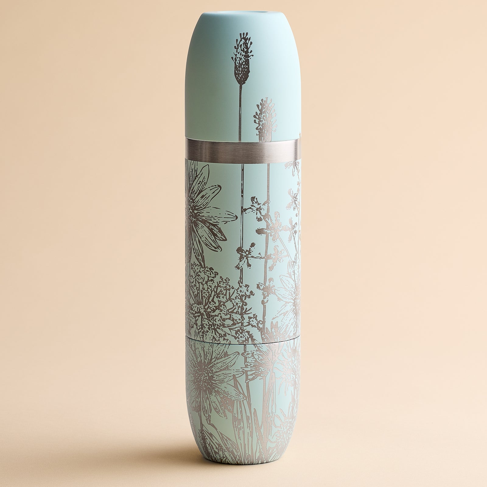 Caskata x High Camp Light Blue Summer Wine Flask by Caskata, featuring a silver floral pattern and matching lid, shown against a plain beige background.