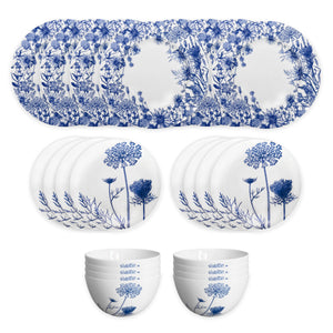 The Summer Blues Table for 8 by Caskata is a 24-piece porcelain dinnerware set with six oval platters, six round plates, and six bowls, all featuring elegant blue and white floral patterns.