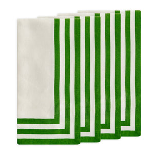 Four white Caskata Triple Stripe Verde Dinner Napkins, crafted from machine washable cotton with parallel green borders, are neatly stacked in a slightly fanned arrangement.