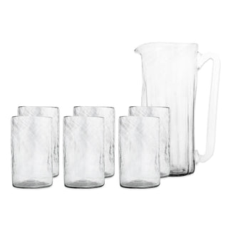 The Viento Essentials Serving Bundle by Caskata features a clear handblown glass pitcher with handle and six matching glass tumblers, shown on a plain white background.