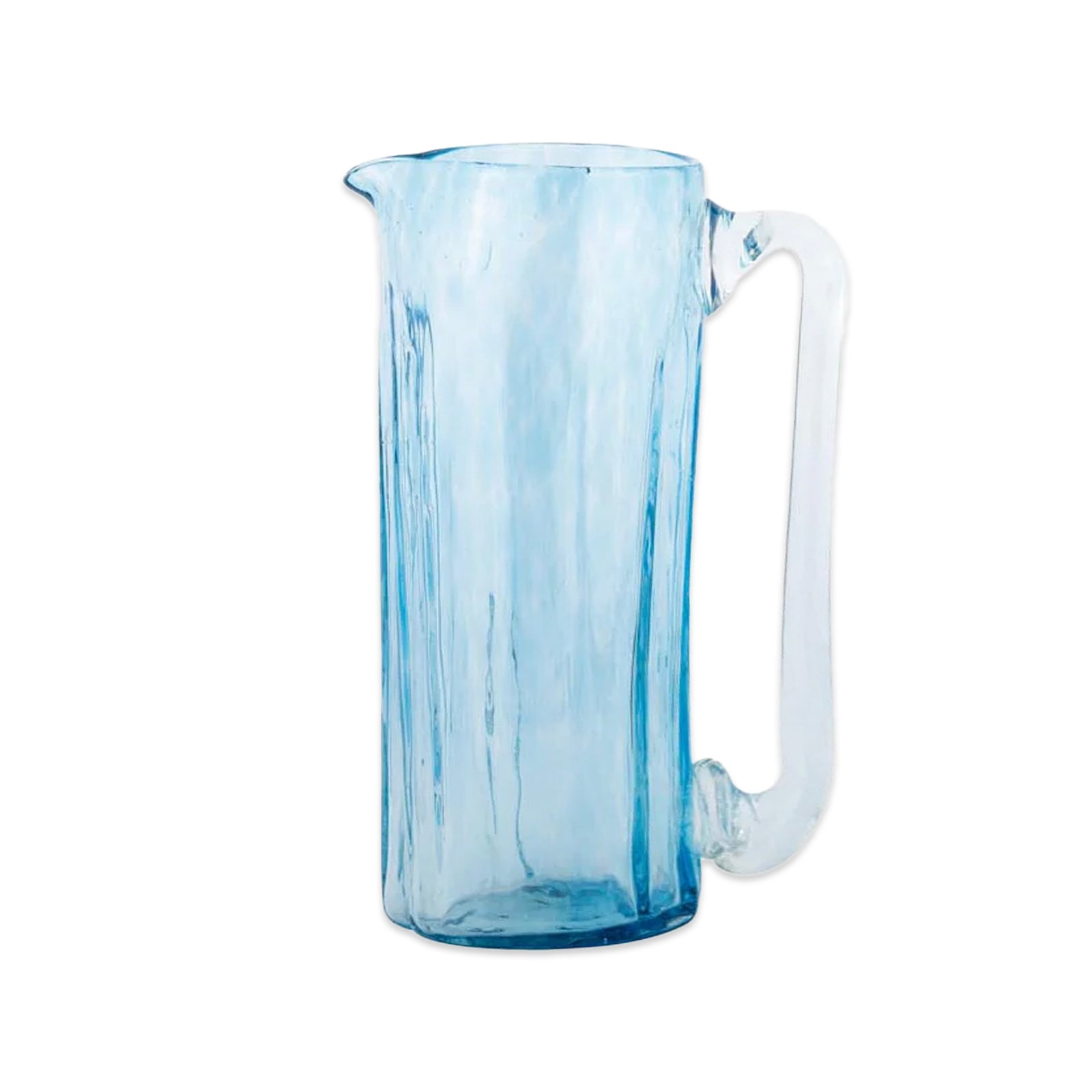 The Caskata Viento Large Blue Pitcher is a tall, handblown glass piece with a wide cylindrical body and curved handle, crafted from transparent blue glass and displayed against a white background.