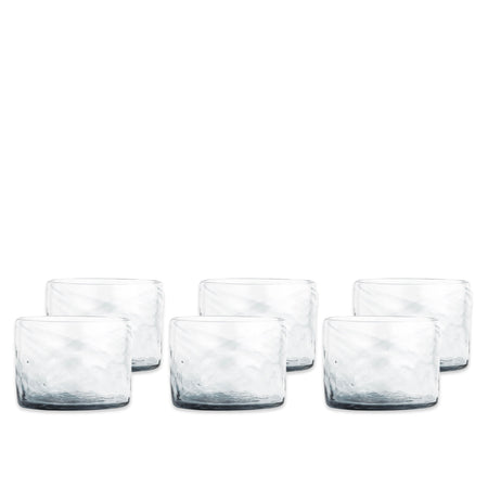 Caskata’s Viento Small Clear Tumblers, Set of 6, crafted from recycled glass, feature a textured handblown design and are shown in two rows on a white background.