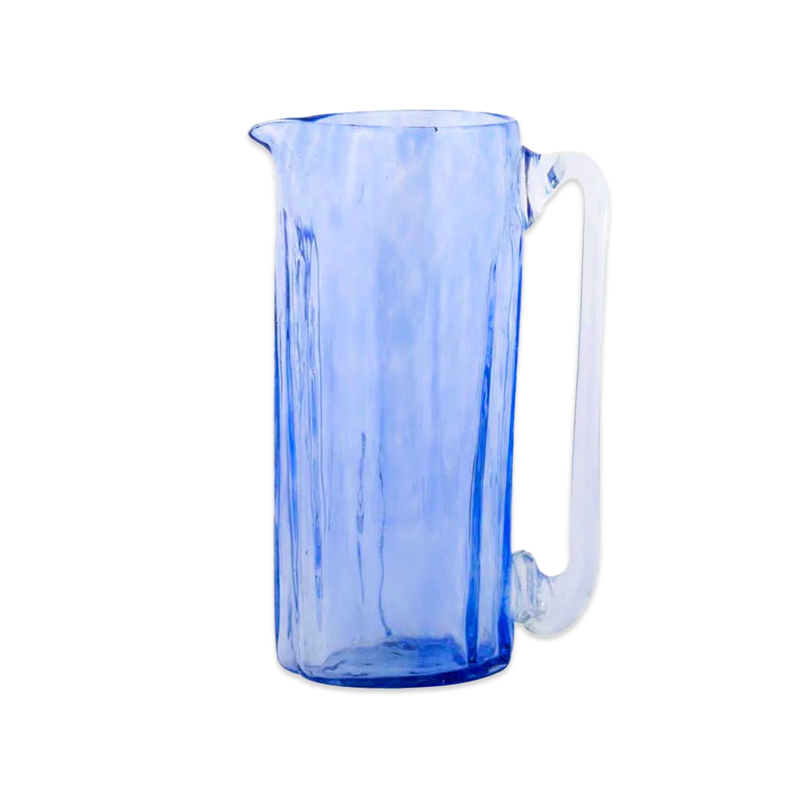 The Caskata Viento Large Cobalt Pitcher is a tall, handblown piece made from recycled glass. It features a transparent blue body with a long, clear handle and is displayed on a white background.