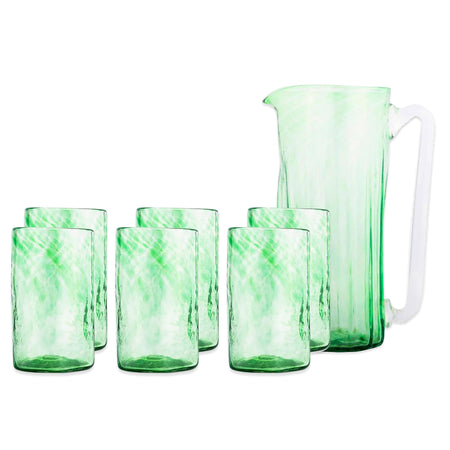 The Grass is Greener Serving Bundle by Caskata features a green Mexican pitcher with a handle and six matching handblown marbled tumblers—an artisanal glassware set.