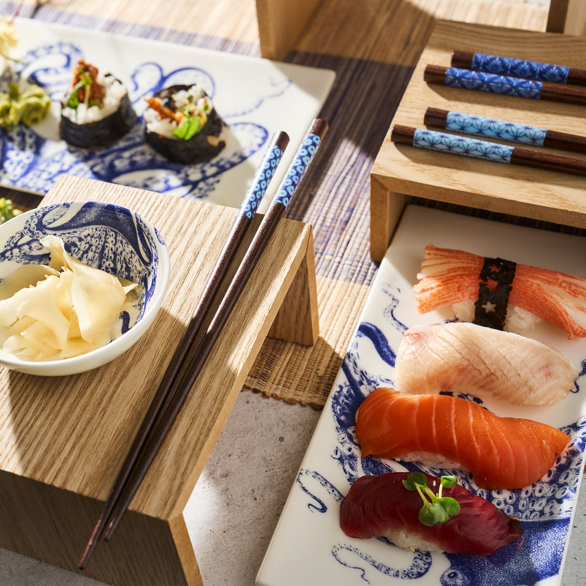 Lucy Sushi Tray Set of 2 by Caskata on small trays with chopsticks.