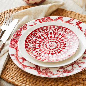 Arcadia Crimson red and white premium porcelain dinner plate from Caskata paired with a red and white Casablanca canape plate on a rattan placemat.