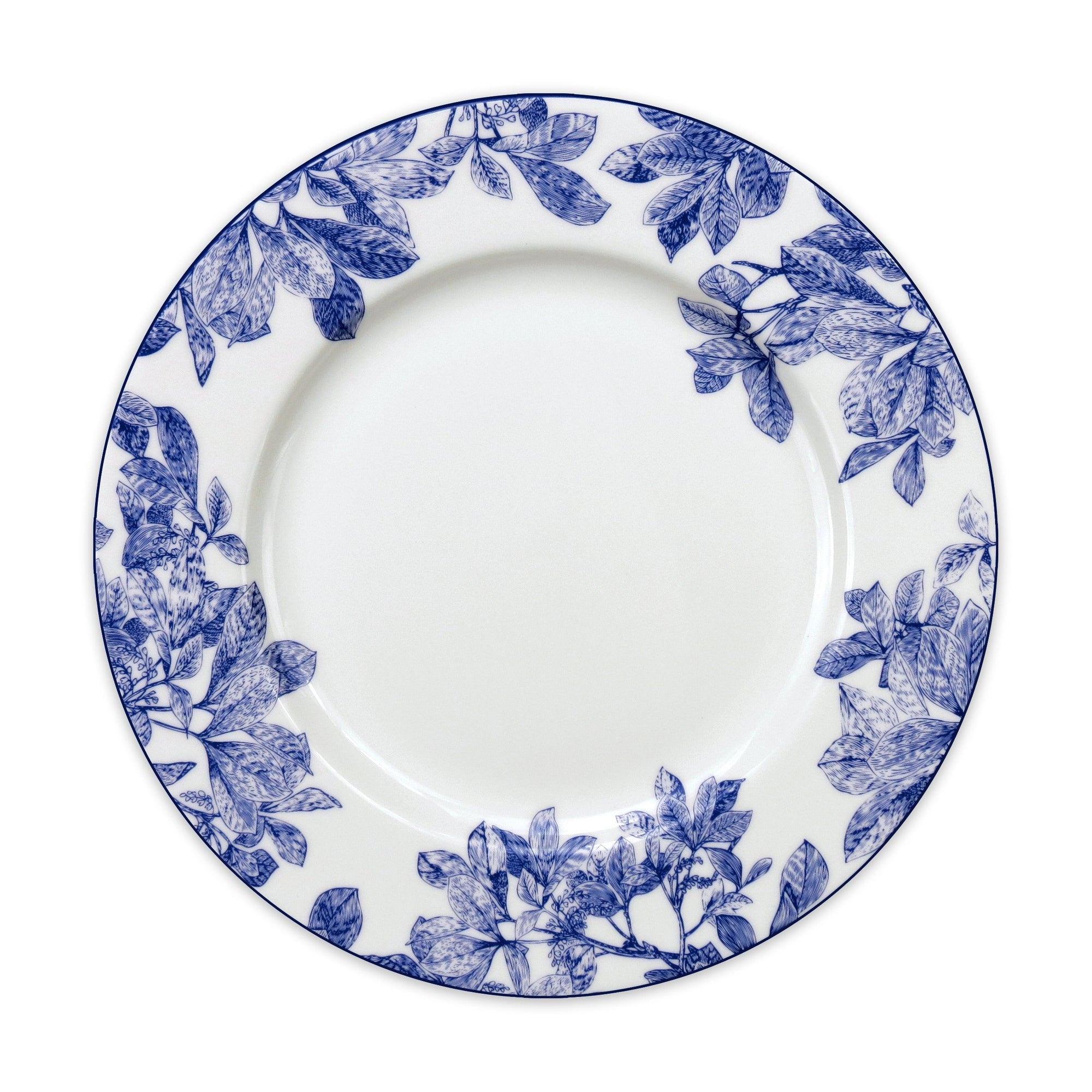 A white ceramic plate with delicate botanical details and blue floral patterns around the rim, this Arbor Rimmed Dinner Plate by Caskata Artisanal Home exemplifies heirloom-quality dinnerware.