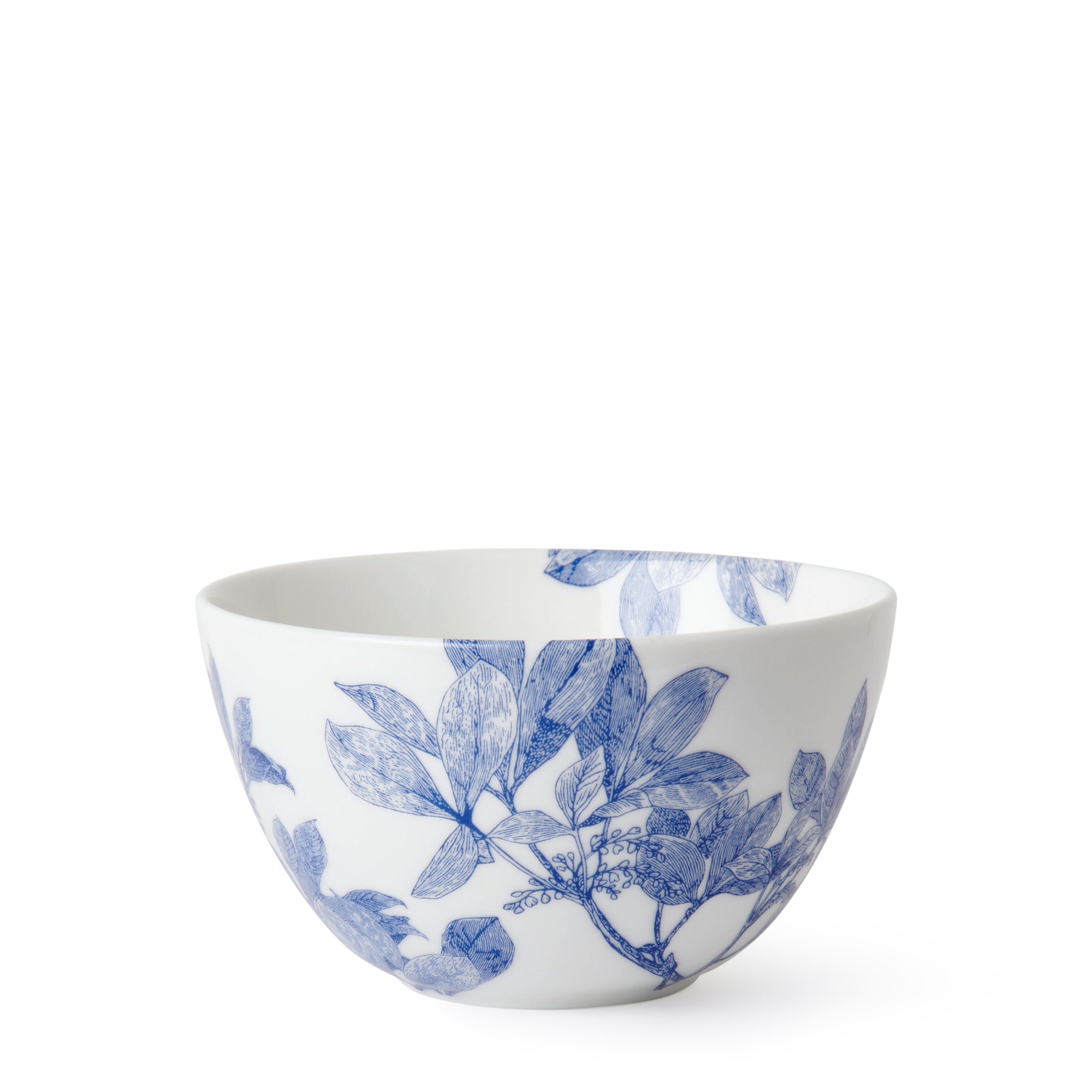 A white ceramic Arbor Cereal Bowl by Caskata with blue floral patterns features detailed leaves and branches, crafted from premium porcelain.