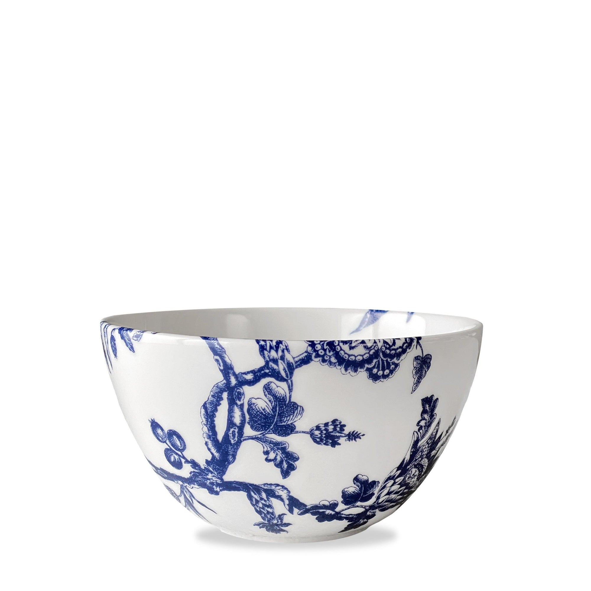 Introducing the Arcadia porcelain dinnerware collection, featuring the Caskata Arcadia Cereal Bowl with a delicate blue floral and tree branch pattern inspired by the Williamsburg Foundation's timeless designs.