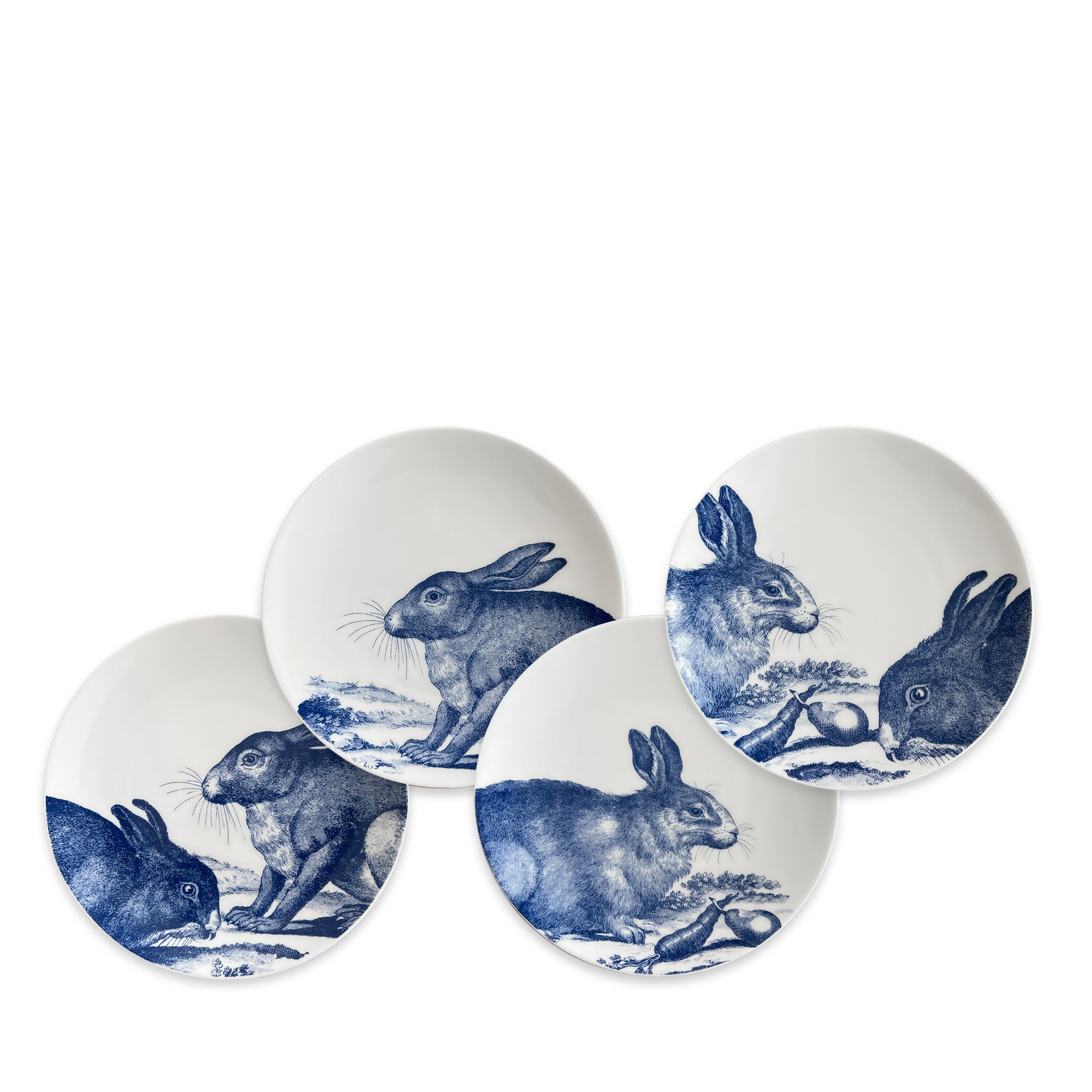 Four high-fired porcelain plates featuring blue illustrations of rabbits in various poses, called Bunnies Small Plates by Caskata Artisanal Home.