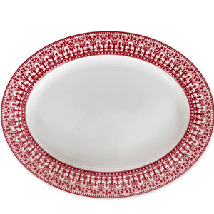 An empty white Casablanca Crimson Oval Rimmed Platter by Caskata Artisanal Home featuring an intricate red decorative border pattern, perfect for adding a touch of elegance to your dinnerware collection.
