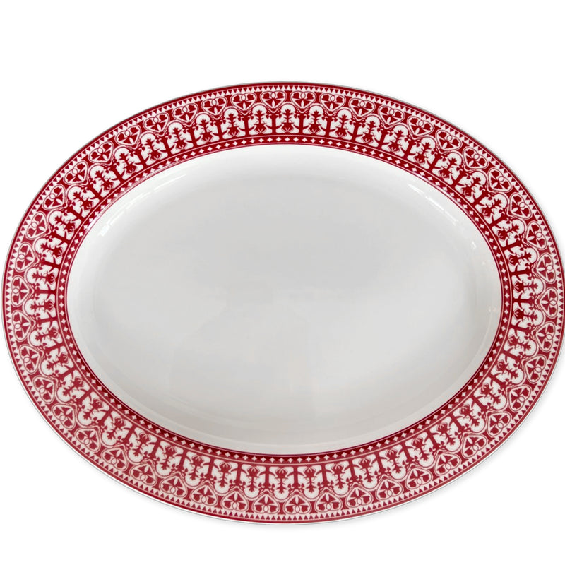 An empty white Casablanca Crimson Oval Rimmed Platter by Caskata Artisanal Home featuring an intricate red decorative border pattern, perfect for adding a touch of elegance to your dinnerware collection.