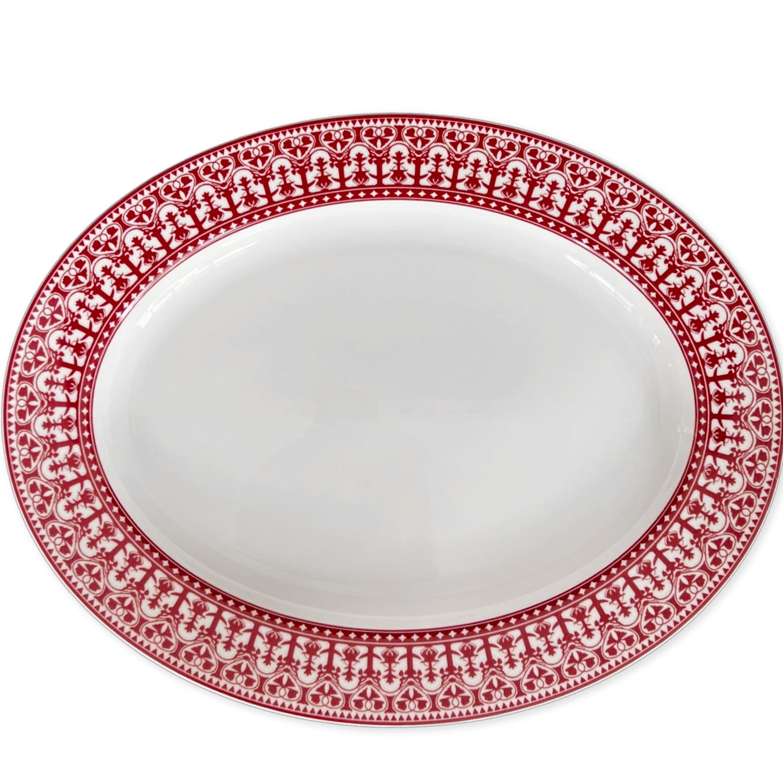 An empty white Casablanca Crimson Oval Rimmed Platter by Caskata Artisanal Home featuring an intricate red decorative border pattern, perfect for adding a touch of elegance to your dinnerware collection.