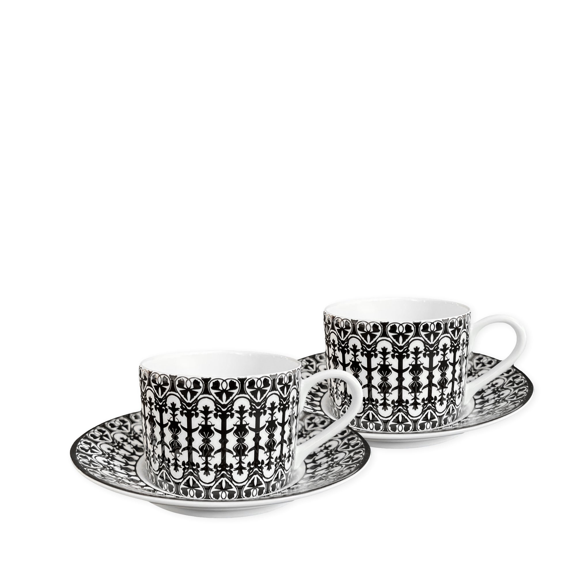 Two white **Casablanca Cups & Saucers, Set of 2** by **Caskata**, featuring black and white intricate patterns, add timeless elegance to any dinnerware collection.