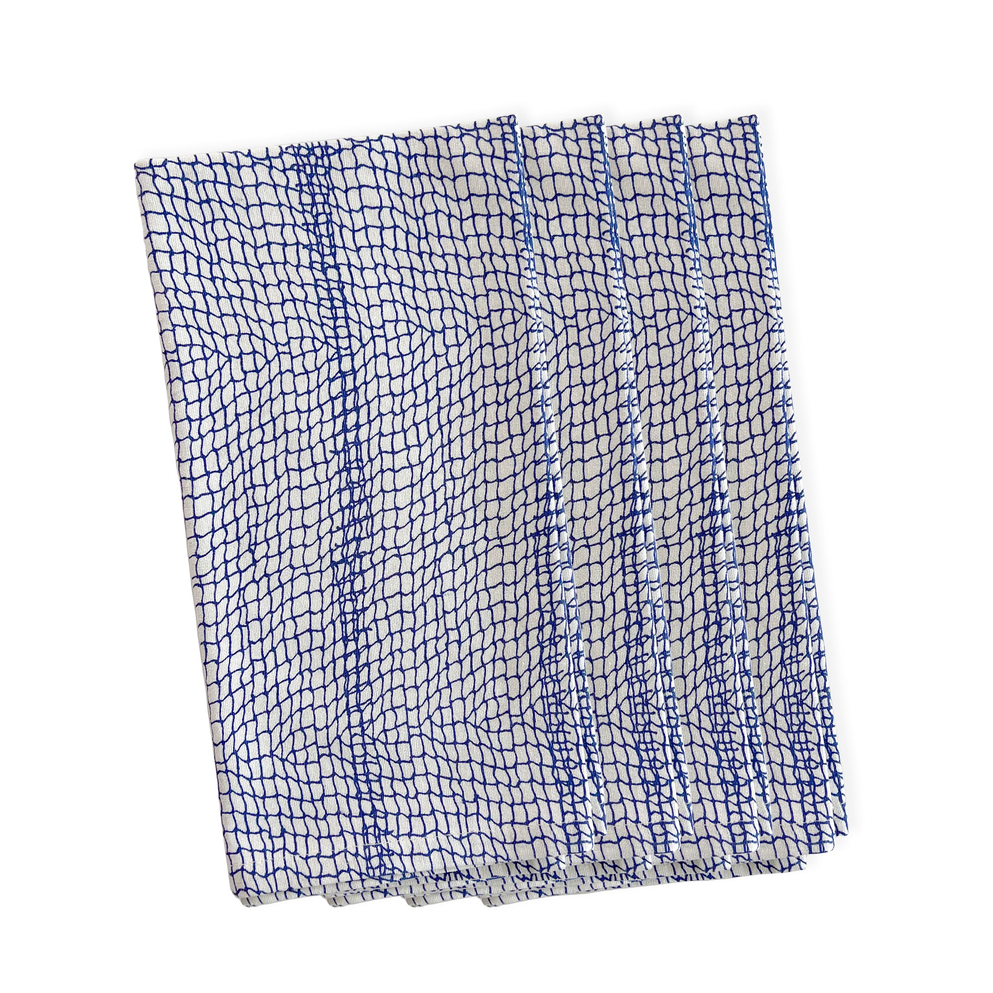 A stack of five folded Catch Dinner Napkins, Set of 4 by Caskata with a blue coastal pattern.