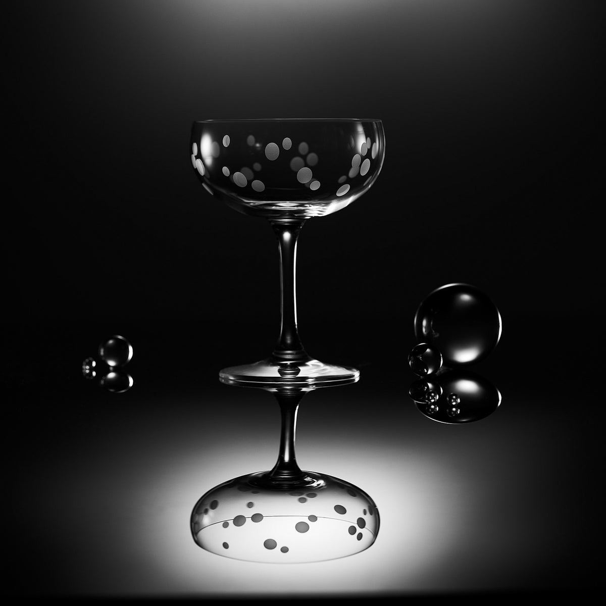 A Chatham Pop etched coupe cocktail glass by Caskata with glass marbles.