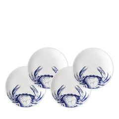 Four heirloom-quality Caskata Artisanal Home Crab Small Plates featuring a charming blue crab pattern on the side are elegantly arranged together.