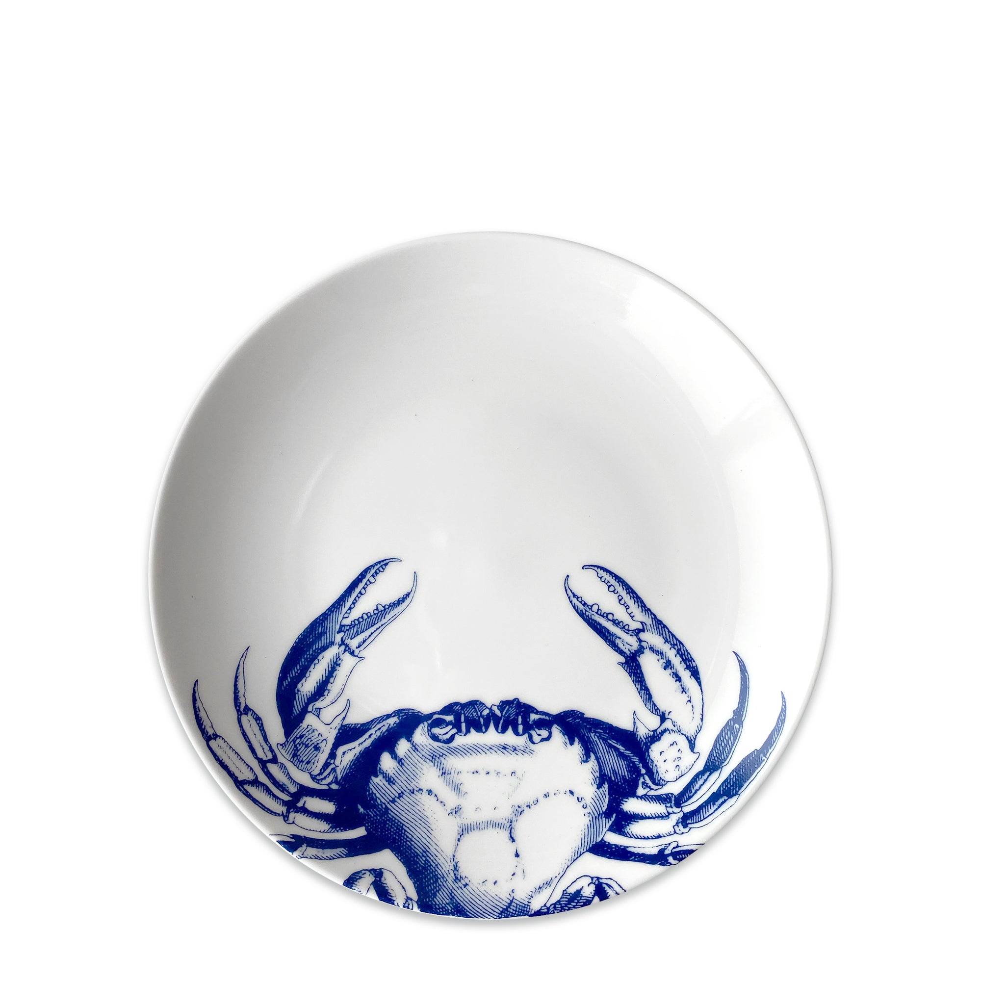 A Crab Coupe Salad Plate by Caskata Artisanal Home, made of premium porcelain, features a detailed blue crab pattern at the bottom.