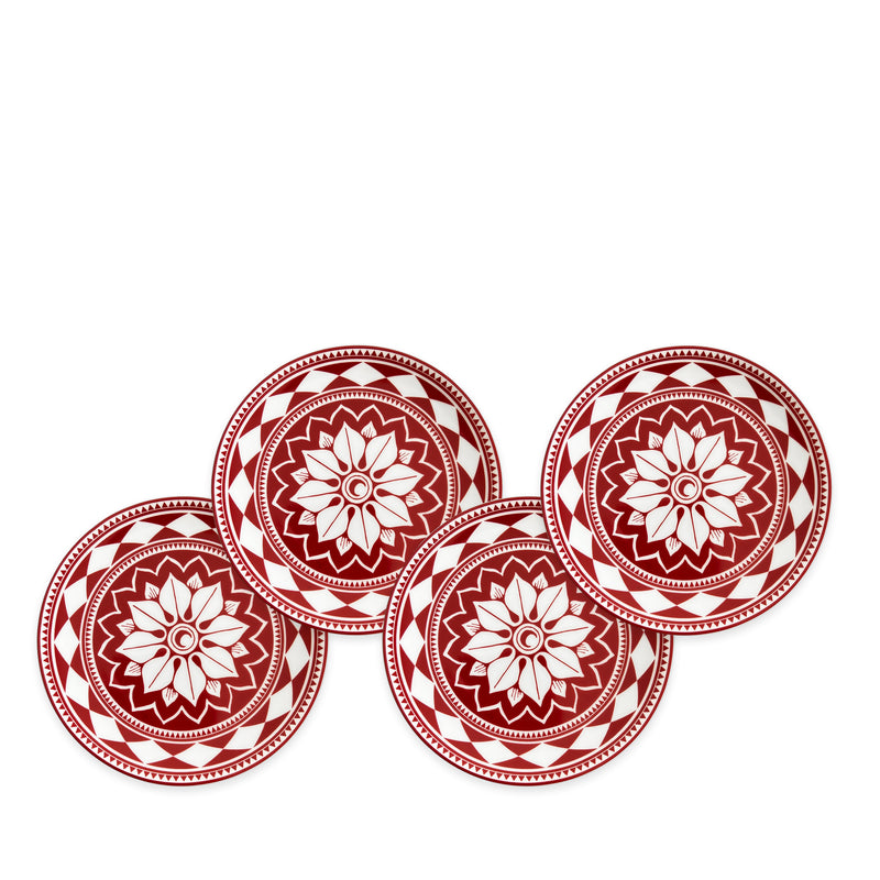 Four red and white ceramic plates with bold geometric floral designs are arranged in a slightly overlapping line against a white background, showcasing Fez Crimson Small Plates by Caskata Artisanal Home—heirloom-quality dinnerware perfect for any entertaining powerhouse.