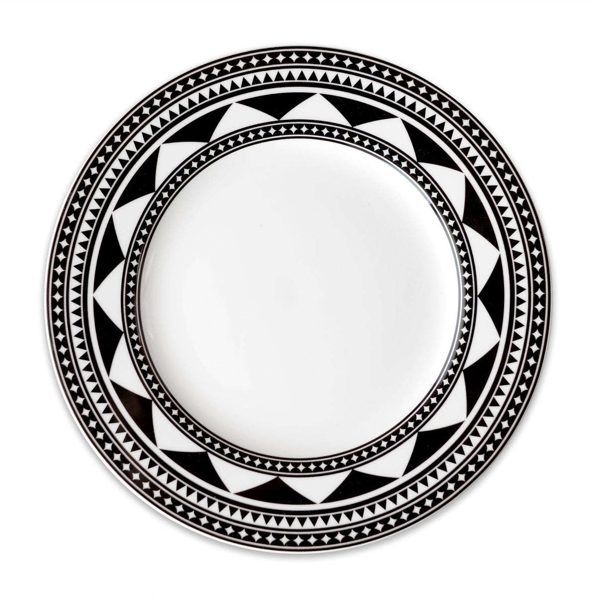 A Fez Rimmed Dinner Plate by Caskata Artisanal Home, a white plate with a wide rim, showcasing a black and white geometric pattern reminiscent of Moroccan designs.