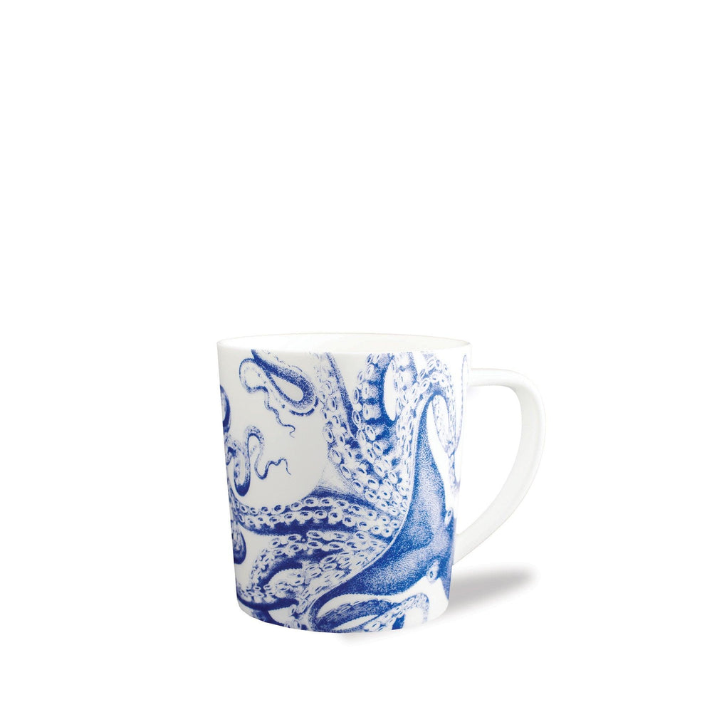 The Lucy Mug by Caskata Artisanal Home features a vivid blue octopus wrapping around white porcelain, perfect for adding coastal charm to your drinkware collection. Shown against a plain white background.