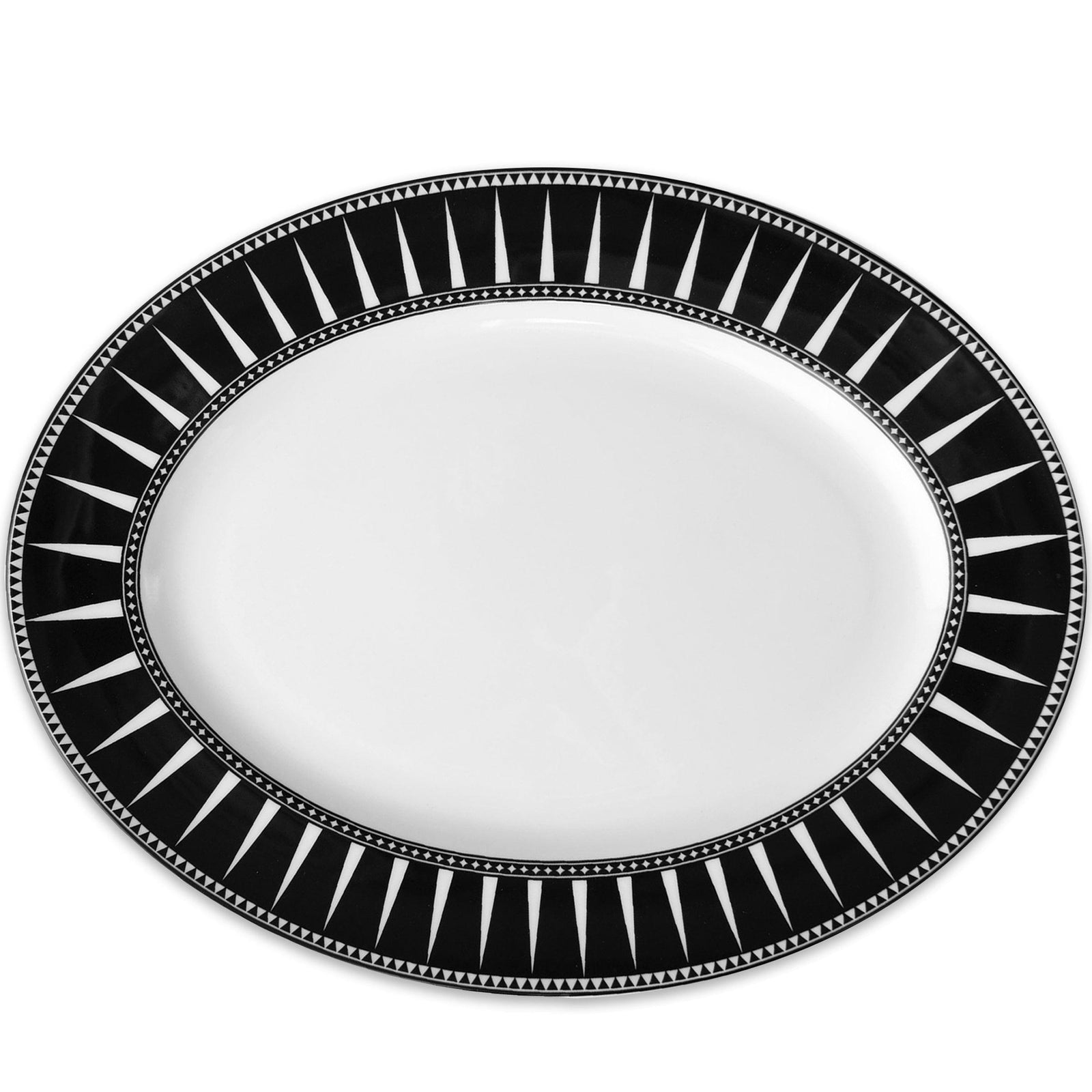 A *Marrakech Oval Rimmed Platter* from *Caskata Artisanal Home*, with a black and white geometric border design, inspired by Moroccan ceramics.