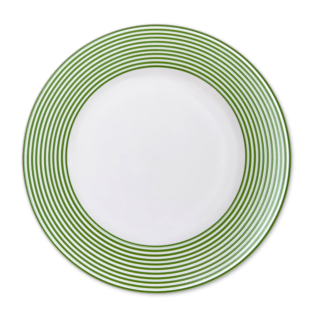 A **Newport Stripe Verde Rimmed Dinner Plate** featuring the Newport Stripe design with closely spaced green concentric circles around the rim, crafted from high-fired porcelain by **Caskata Artisanal Home**.