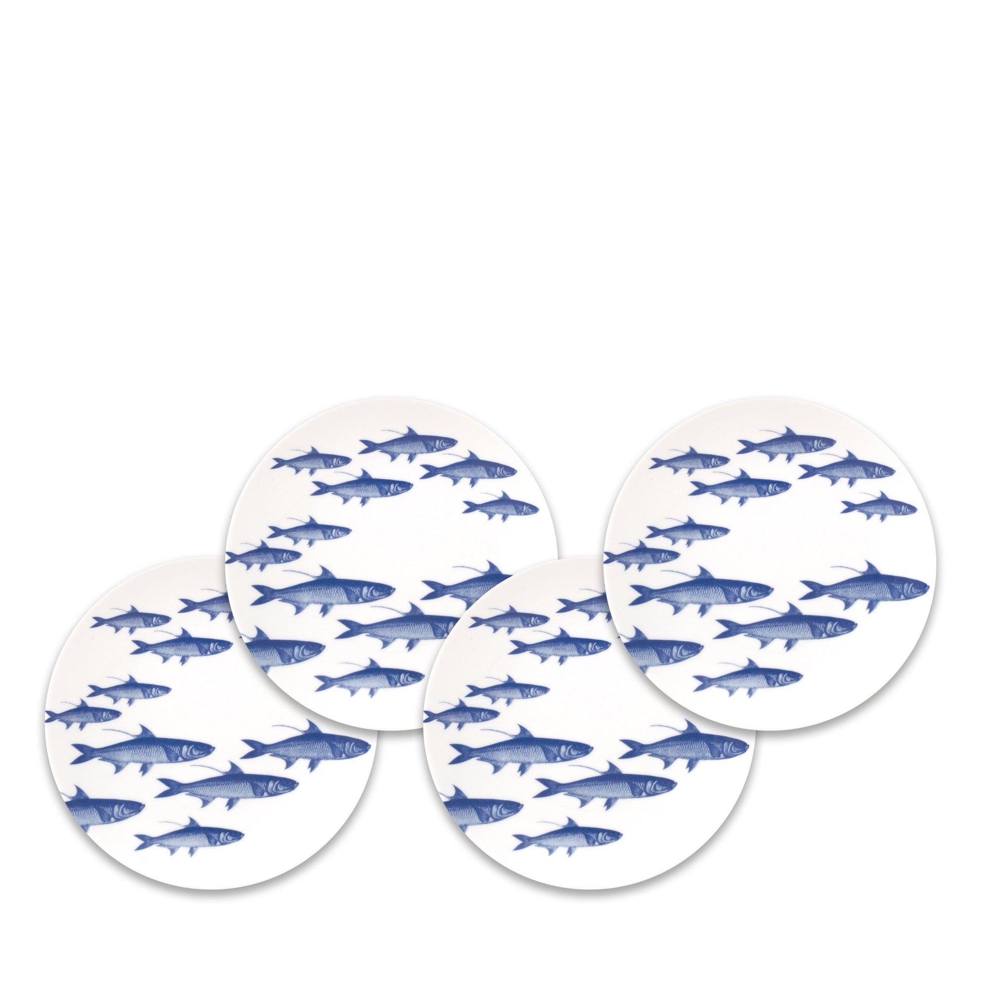 Four white circular plates each featuring a school of blue fish swimming in the same direction on a white background. This heirloom-quality dinnerware, the School of Fish Small Plates by Caskata Artisanal Home, is not only visually striking but also microwave safe, blending functionality with elegant design.