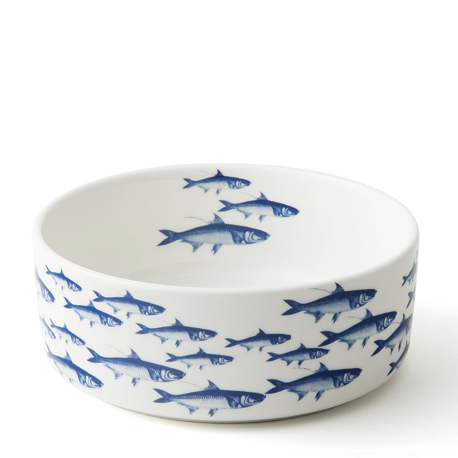 The "Pampered Pet" Bundle by Caskata features two medium porcelain bowls with blue ocean designs—an octopus and a fish—arranged on a white table with treats and tags. These charming bowls elevate any pet dinnerware collection.