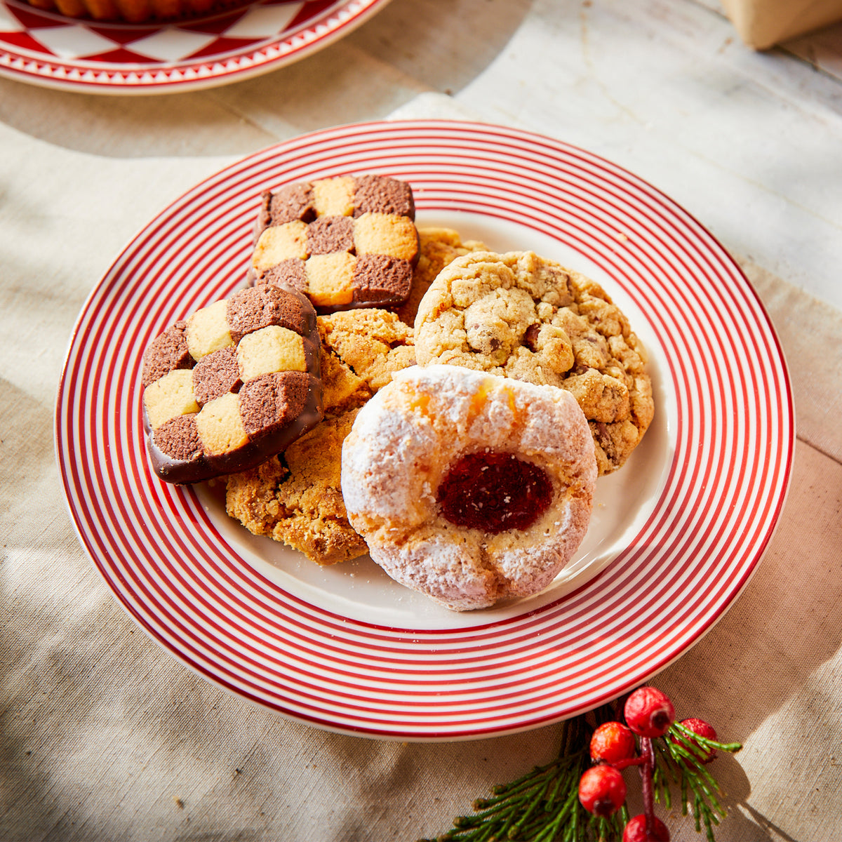 A premium porcelain Newport Stripe Crimson salad plate by Caskata holds cookies.