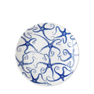 A round Starfish Coupe Salad Plate crafted from premium porcelain, adorned with a charming blue starfish design pattern by Caskata Artisanal Home.