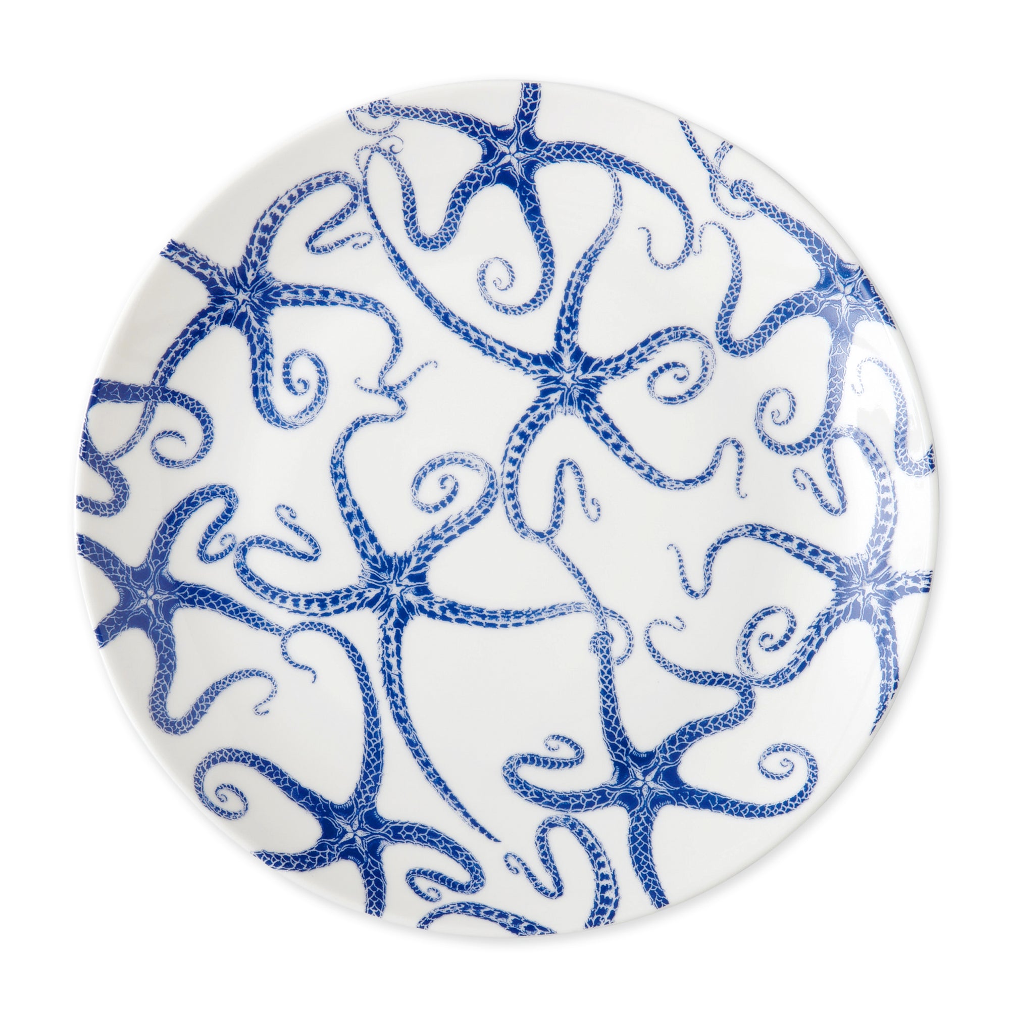 A Caskata Artisanal Home Starfish Coupe Dinner Plate featuring a contemporary shape and a pattern of blue octopus illustrations.